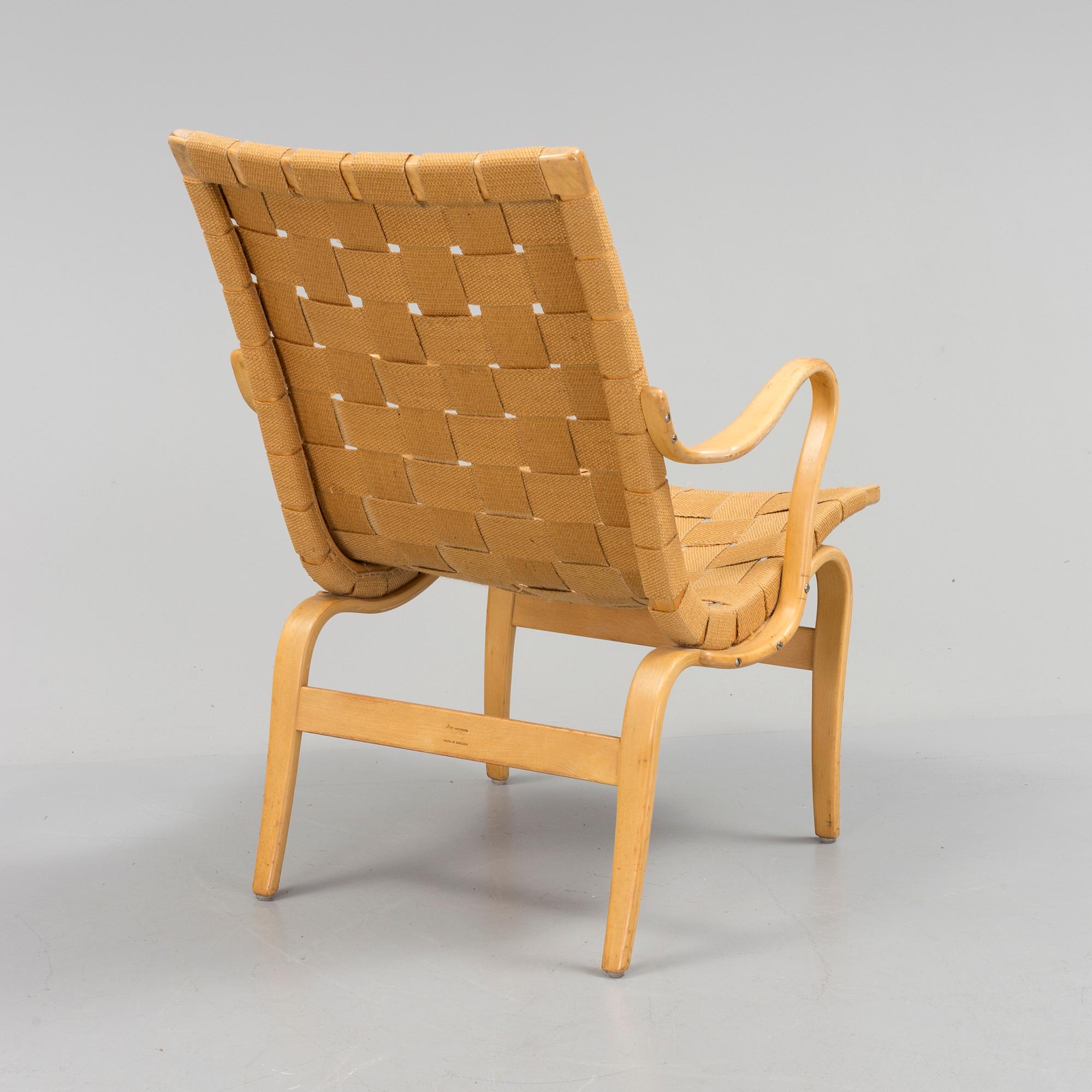an "Eva" armchair by BRUNO MATHSSON 1963.