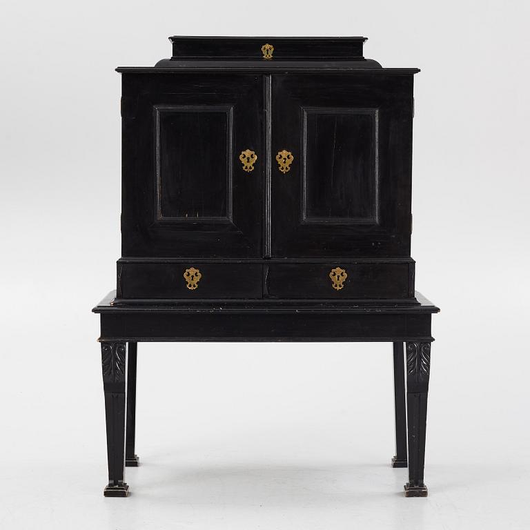 A South-German Baroque ebonized collector's cabinet on stand, circa 1700.