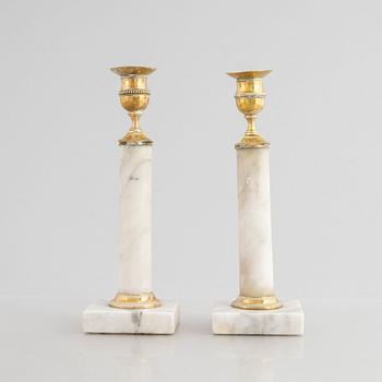 A pair of Gustavian gilt brass and marble candlesticks, late 18th century.