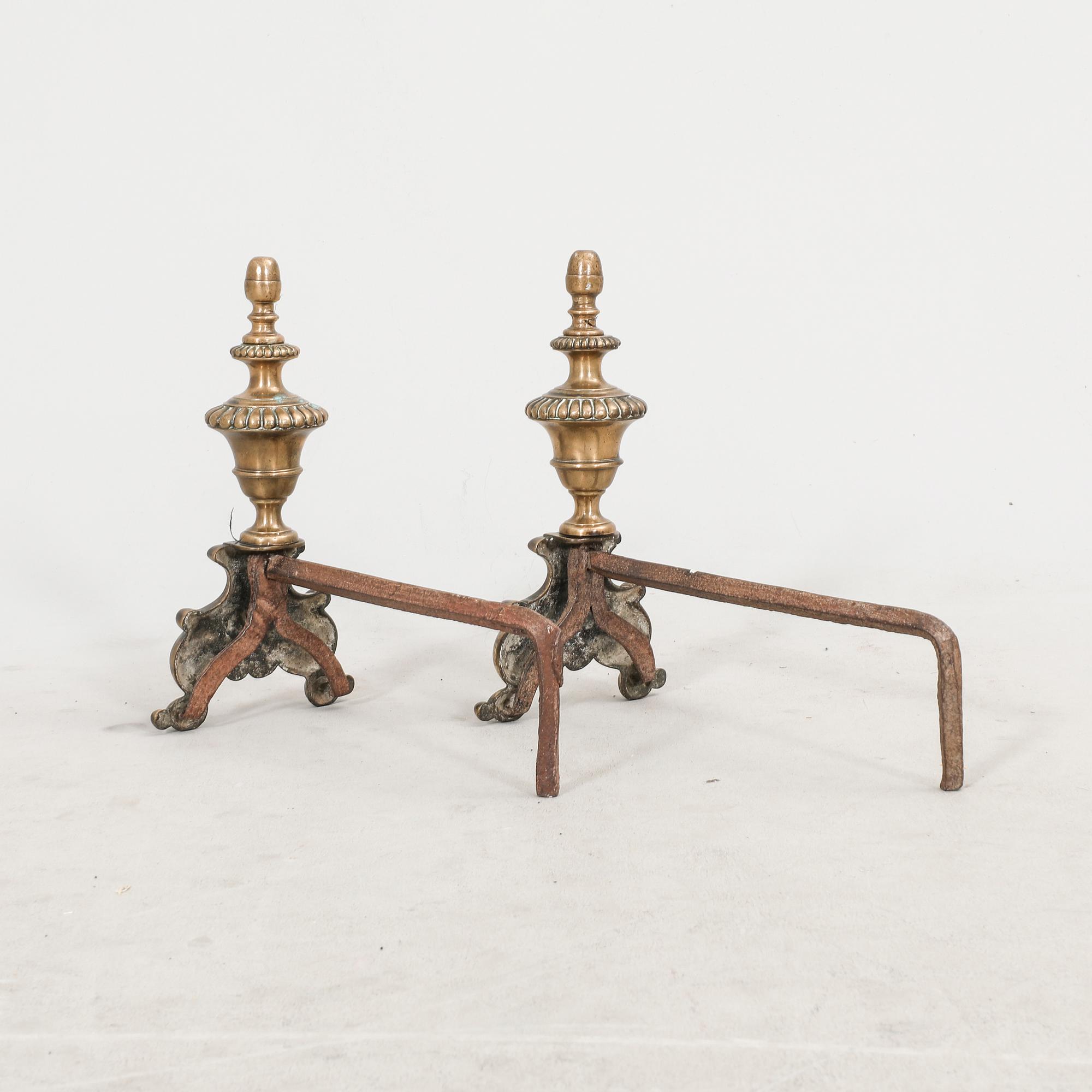 A pair of French metal chenets later part of the 19th century.