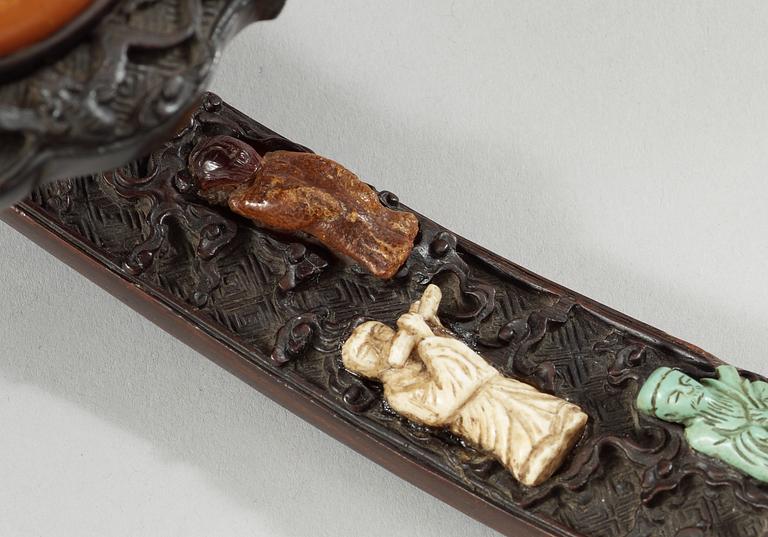 A hardwood Ruyi Sceptre with inlays of nephrite, turquoise, coral and other materials. Qing dynasty, presumably Qianlong.