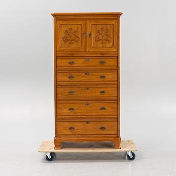 A walnut veneered tall boy dresser, early 20th century.