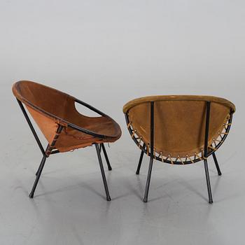 A pair of 1960s-70s steel and leather easy chairs.