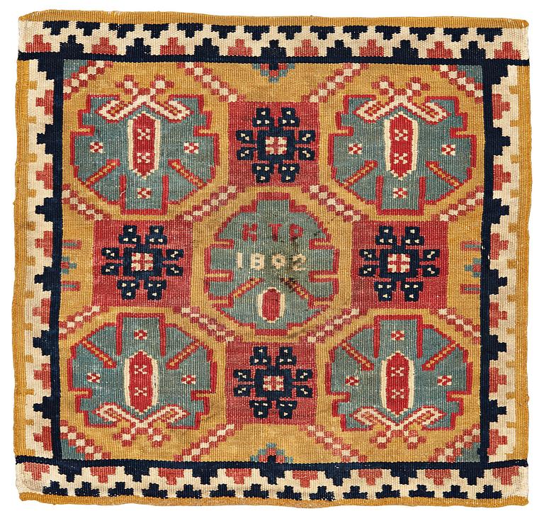 A CUSHION, double-interlocked tapestry, ca 54,5 x 57 cm (with mounting 62 x 64 cm), signed and dated KTD 1802. Scania.