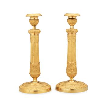 1623. A pair of Empire candlesticks.