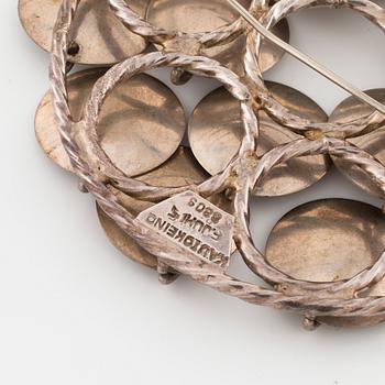 FRANK JUHLS, Kautokeino, Norway, a brooch.