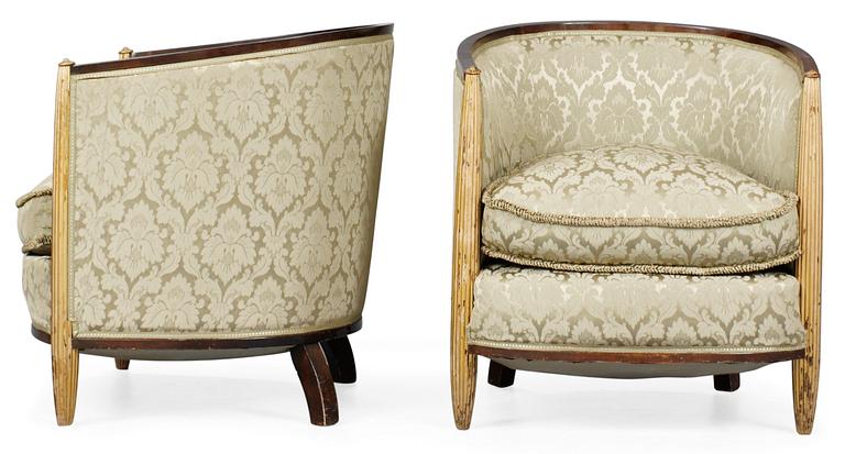 A pair of French partly gilt palisander armchairs in the manner of Poul Follot, 1920-30's.