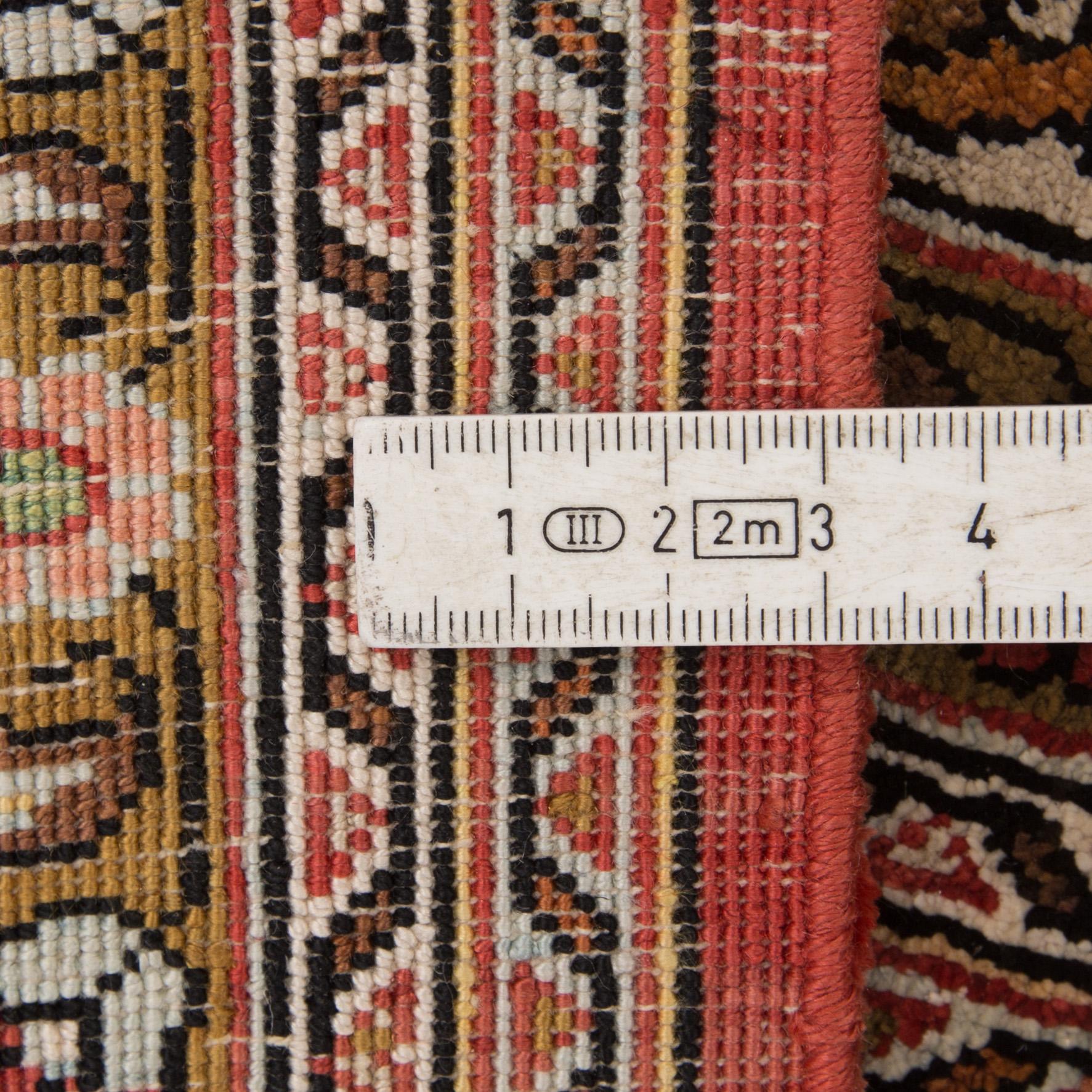 A silk Qum rug, around 220 x 134 cm.