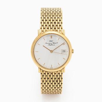 IWC (International Watch Co.), 31 mm, 18K gold, quartz.