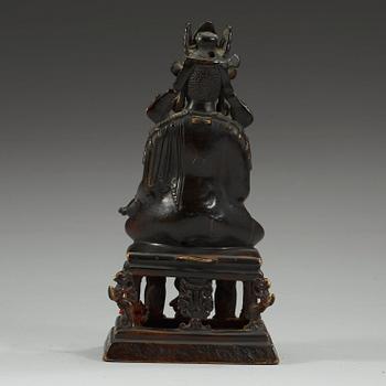 A western Tibetan/Kashmir bronze figure of Maitreya on a high throne, presumably 12th Century or older.