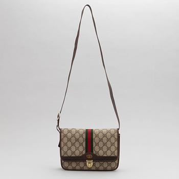 Gucci, a canvas handbag.