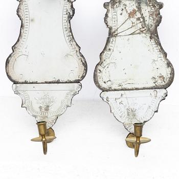 A pair of Nort European late baroque one-light girandole mirrors, mid 18th century.