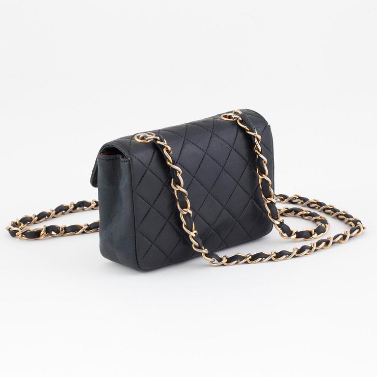 CHANEL, a black quilted leather shoulderbag, "Mini flap bag".