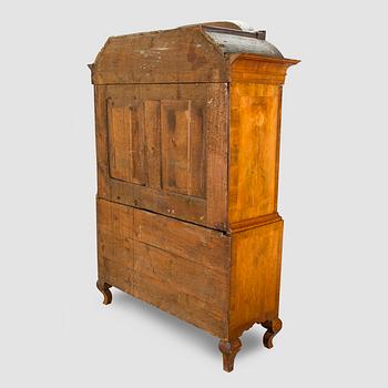 A Swedish walnut-veneered rococo cabinet in the manner of C. Linning, latter half of the 18th Century.