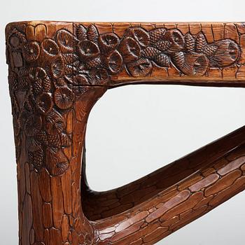 Gustaf Fjaestad, an Art Nouveau carved pine table, Arvika Sweden 1914, a double to the table in the Thiel Collection,