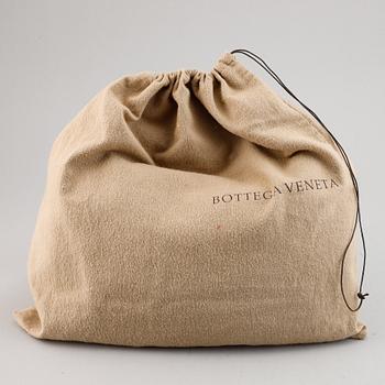 Bottega Veneta, a black leather bag.