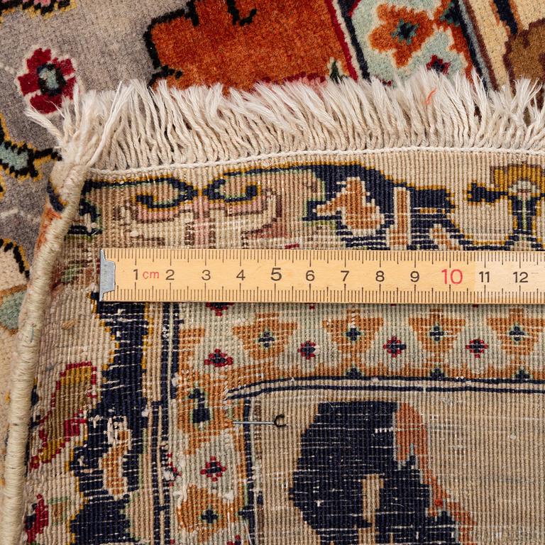 A semi-antique Tabriz carpet, Northwest Persia, of Safavid 'Vase' design, c.328 x 242 cm.