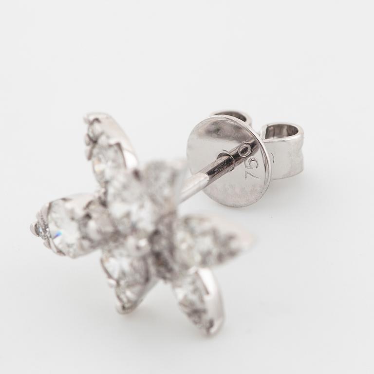 A pair of brilliant cut diamond earrings.