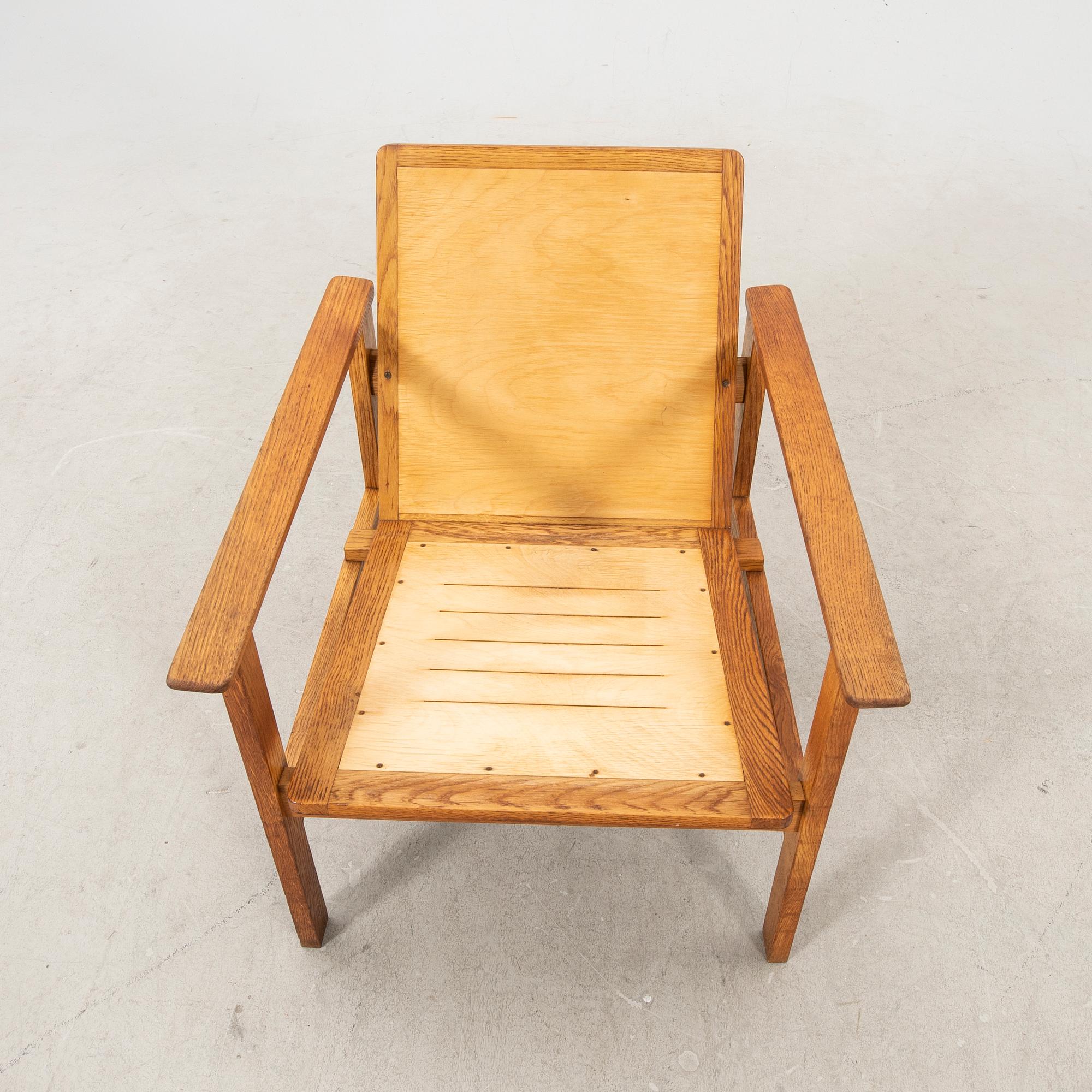 A stained wooden armchair later part of the 20th century.