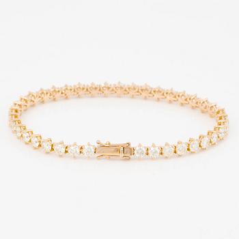 Tennis bracelet in 18K gold with brilliant-cut diamonds.