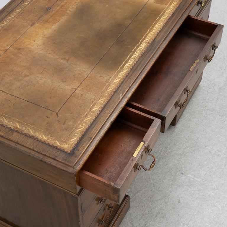 A mahogany and mahogany veneer desk with desk chair, 20th Century.