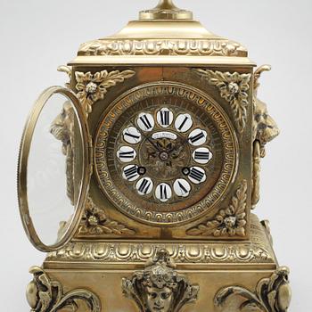 A table clock and two candelabras, around the year 1900.