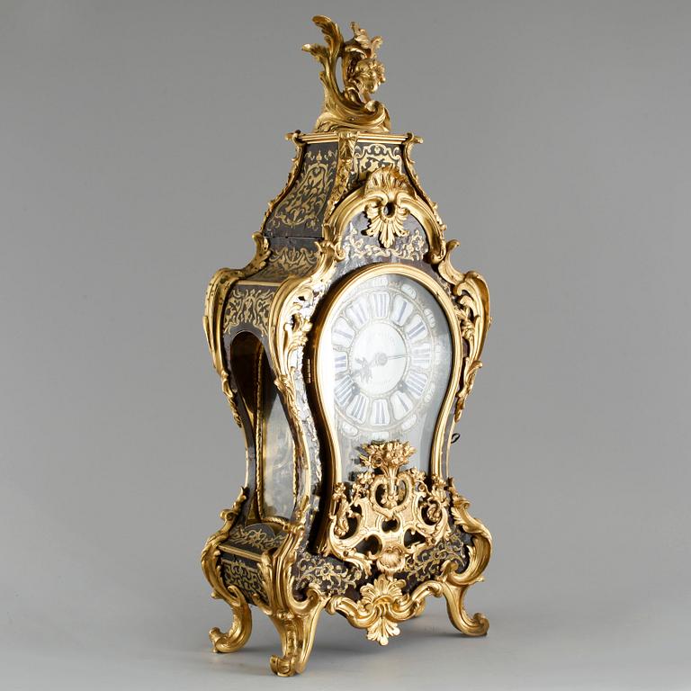 A 19th century mantle clock in the style of Louis XV.