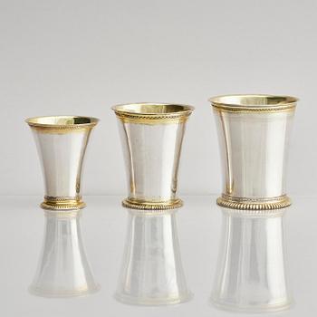 Three Swedish 18th century parcel-gilt silver beakers and a case of birch, different maker's.