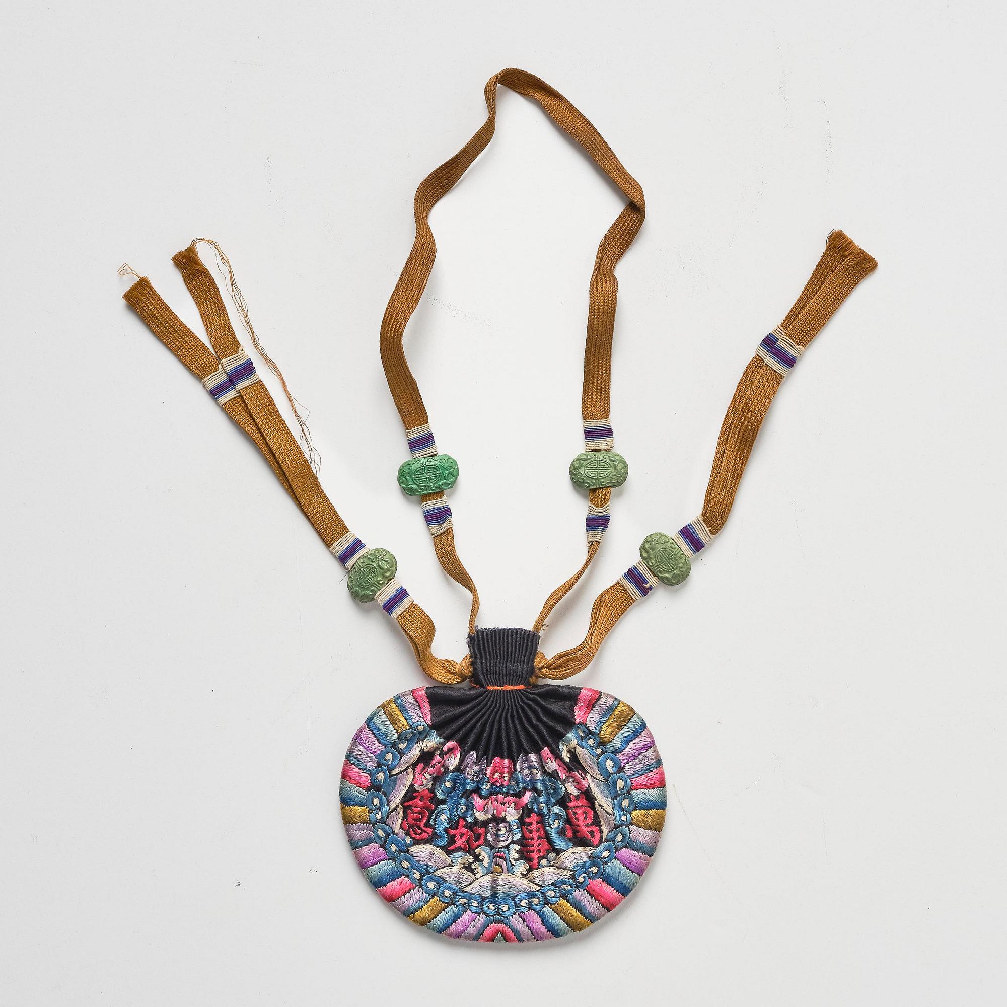 A set of three embroidered purses/ eye-glass cases, Qing dynasty, 19th century.