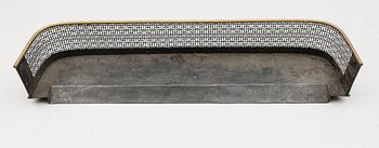 BRASSKYDD, mässing, 1900-talets första hälft.