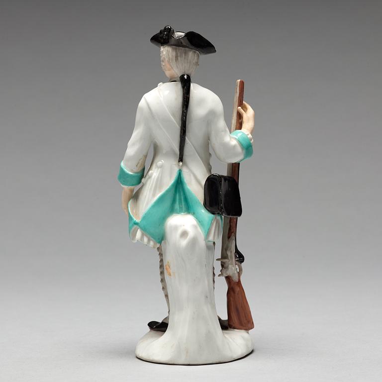 A German unmarked porcelain figure of a huntsman, 18/19th Century.