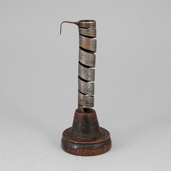 An 18th century wood and iron candlestick.