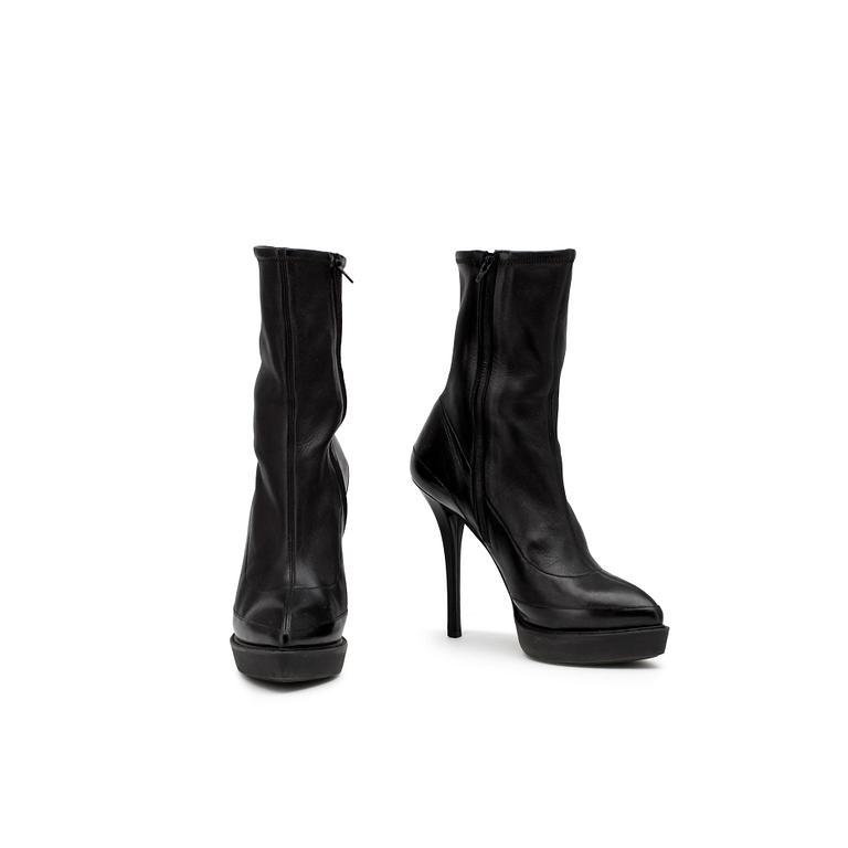 GUCCI, a pair of black leather boots.