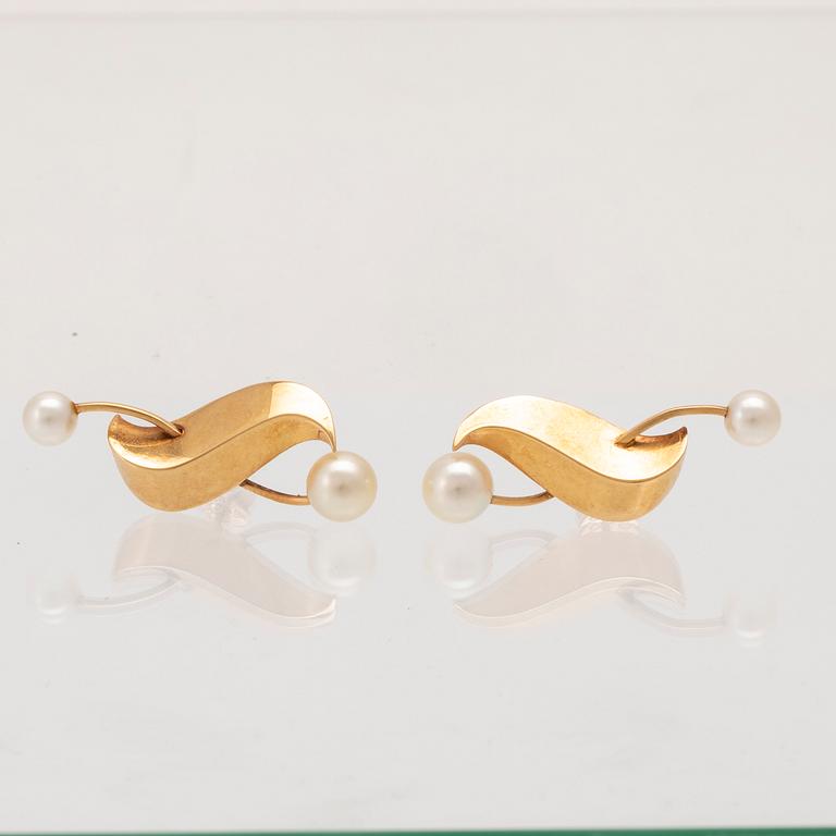 A pair of 18K gold earrings set with cultured pearls by Elon Arenhill.