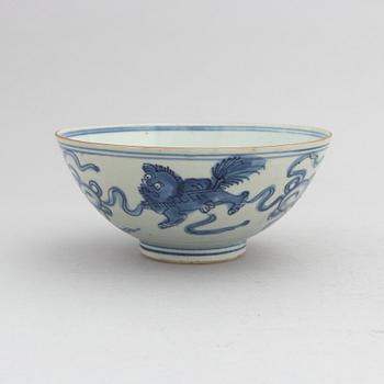 A Chinese blue and white porcelain bowl with buddhist lions chasing a ball with ribbons, Ming dynasty (1368-1644).