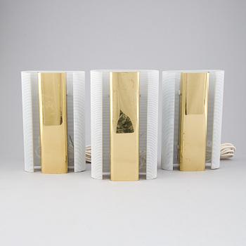 Hans-Agne Jakobsson, a set of three of 'V-451/18L'/'Rasputin' brass wall lights from Markaryd.