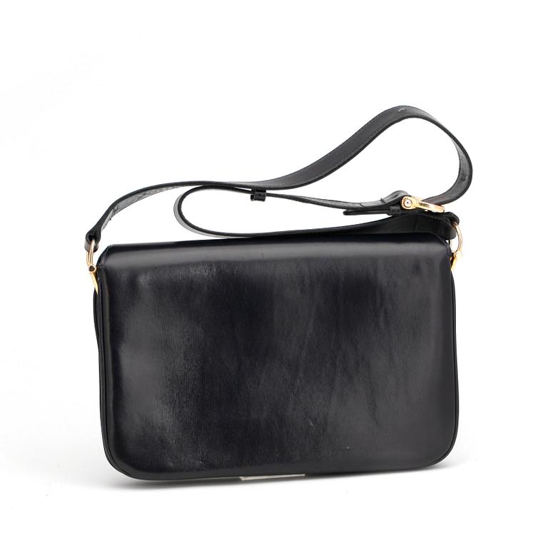 CÉLINE, a dark blue leather shoulder bag.