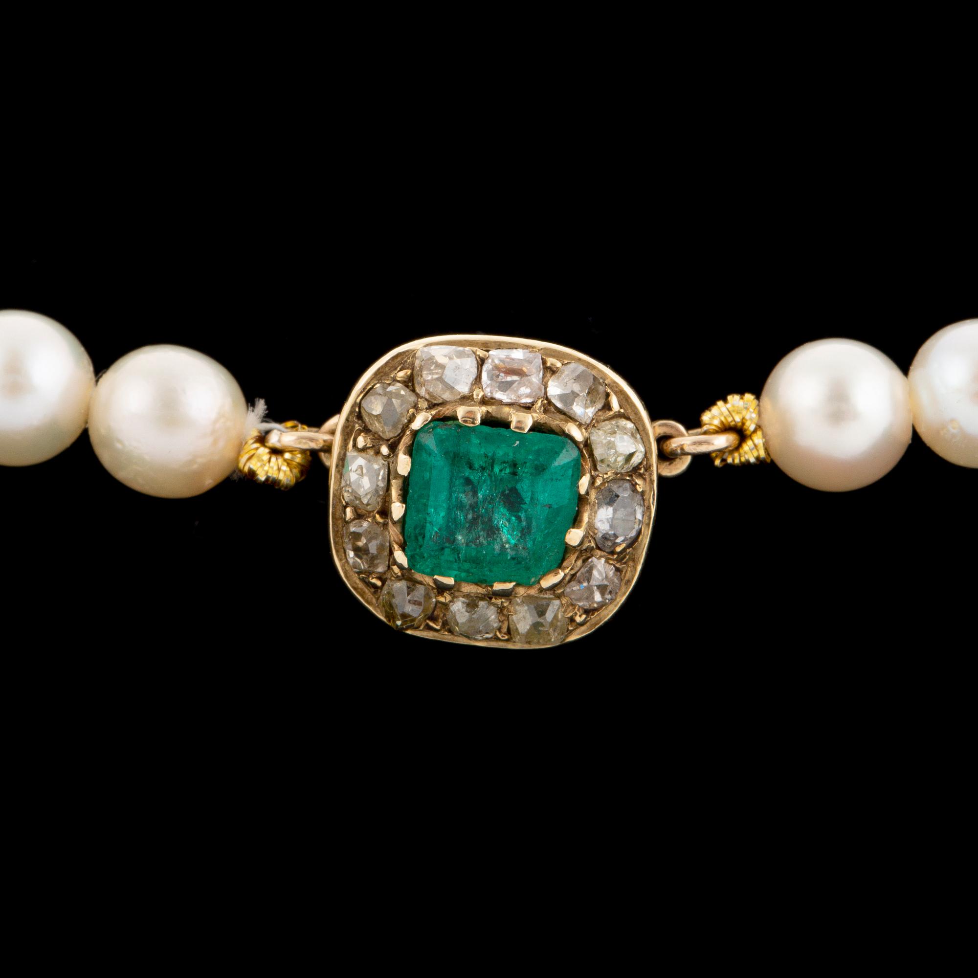 Cultured calibrated pearl necklace, clasp with emerald and old-cut diamonds.