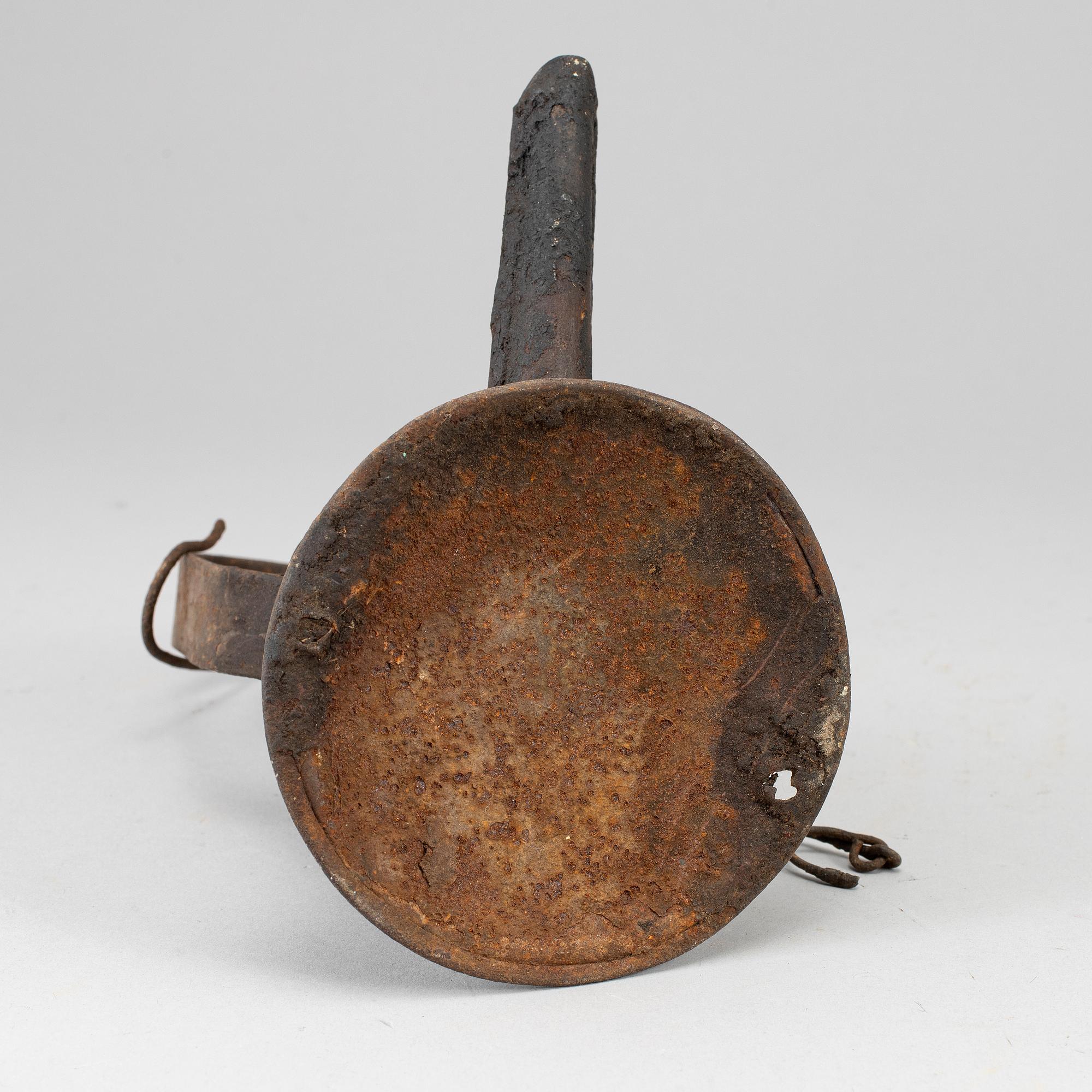 A 19th century tinplate oil lamp.