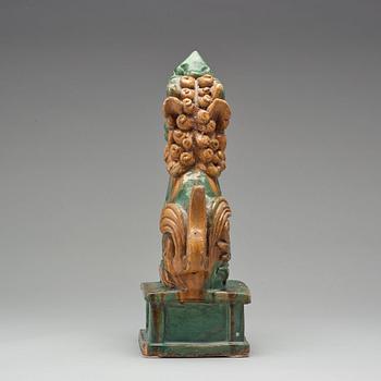 A green and yellow glazed pottery figure of a buddhist lion, presumably Ming dynasty.