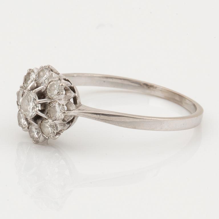 An 18K white gold ring set with round brilliant cut diamonds.