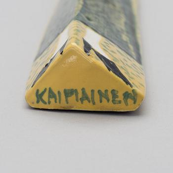 A CERAMIC WALL RELIEF. Small doll. Sign. Kaipiainen.