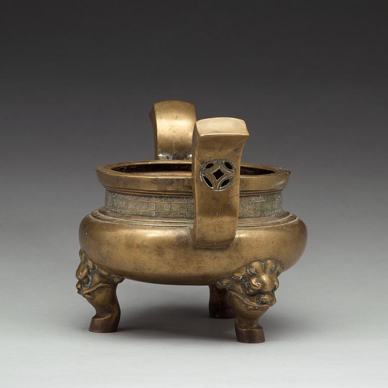 A large brass tripod censer, Qing dynasty (1644-1912).