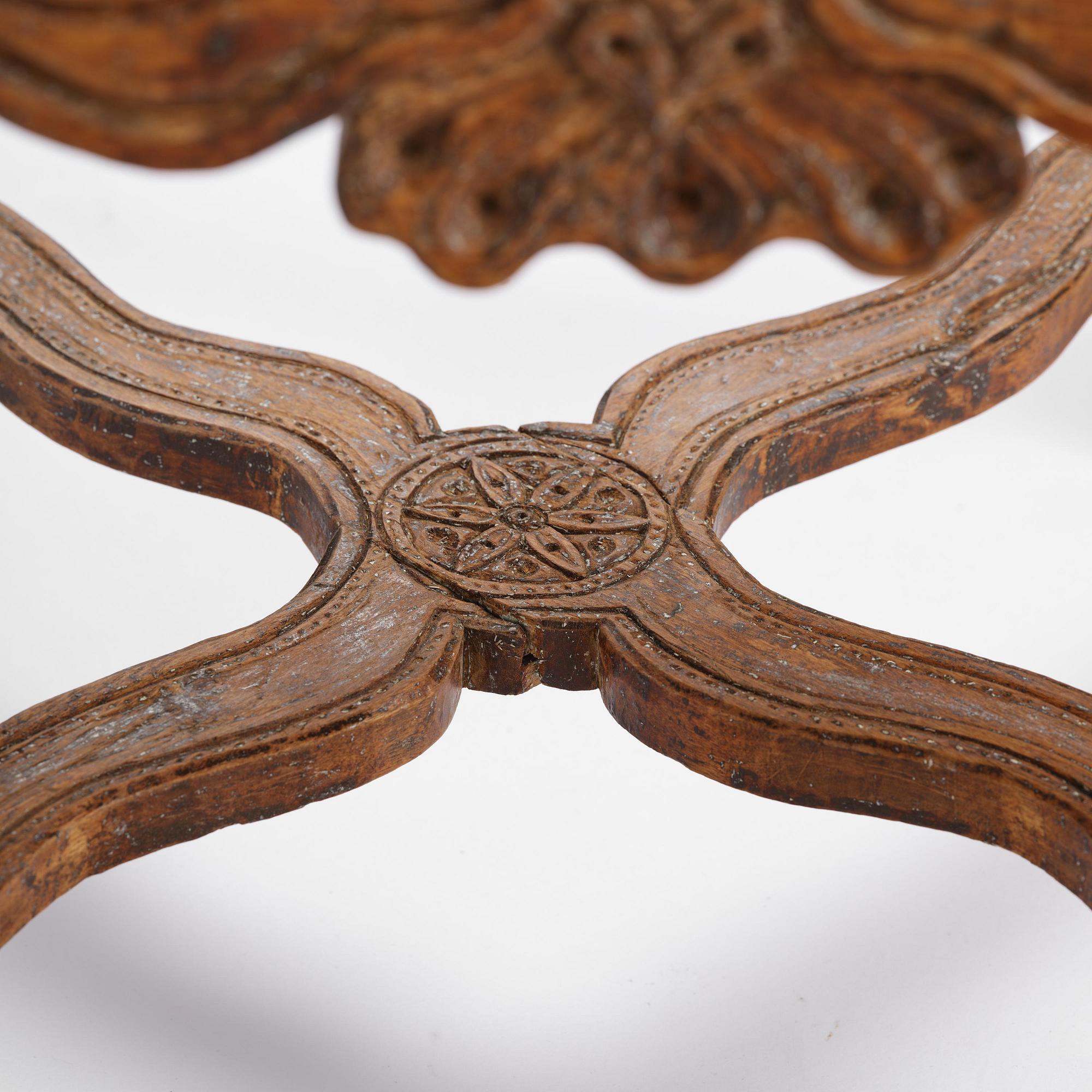 A pair of carved stools in the manner of Jonas Granberg, Jämtland, Sweden, mid 18th century.
