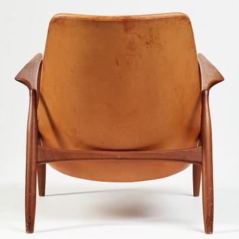 Ib Kofod-Larsen, a "Seal" teak and brown leather armchair, Olof Persson Möbler, Jönköping, Sweden 1950-60's.