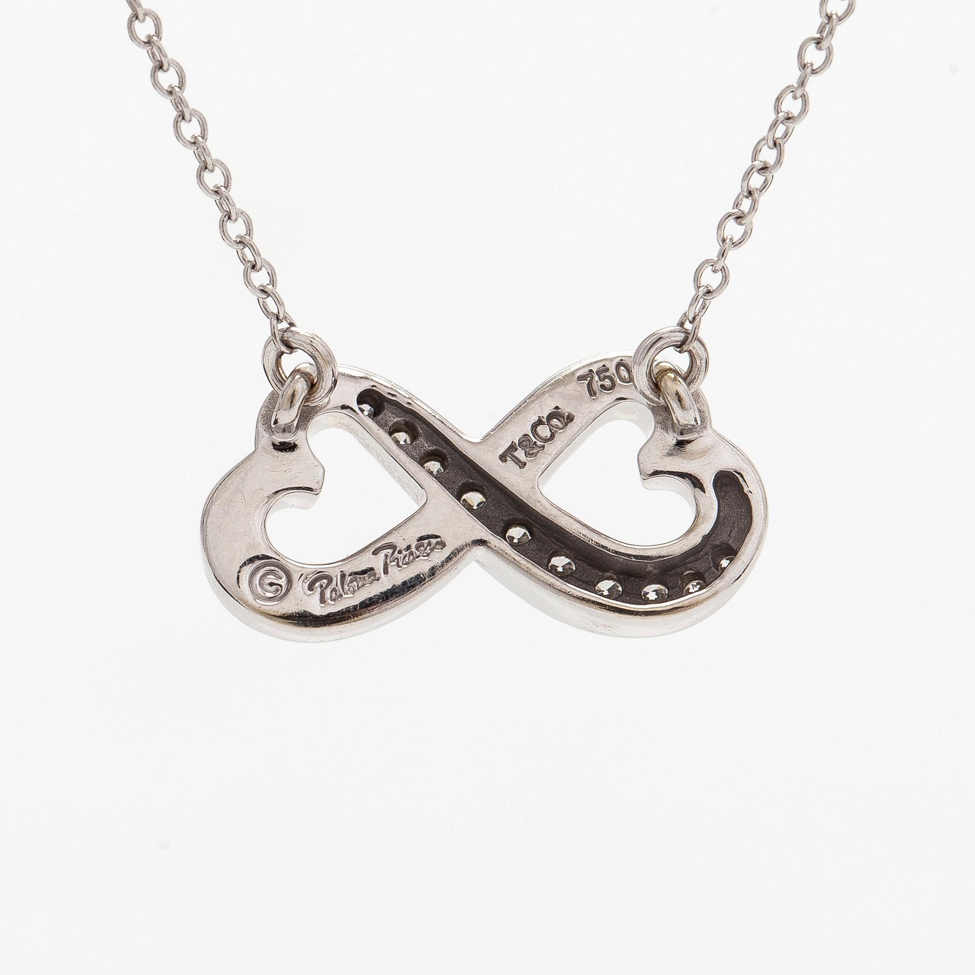 Tiffany & Co, Paloma Picasso, "Double Loving Heart" kaulakoru, 18K valkokultaa ja briljanttihiottuja timantteja.