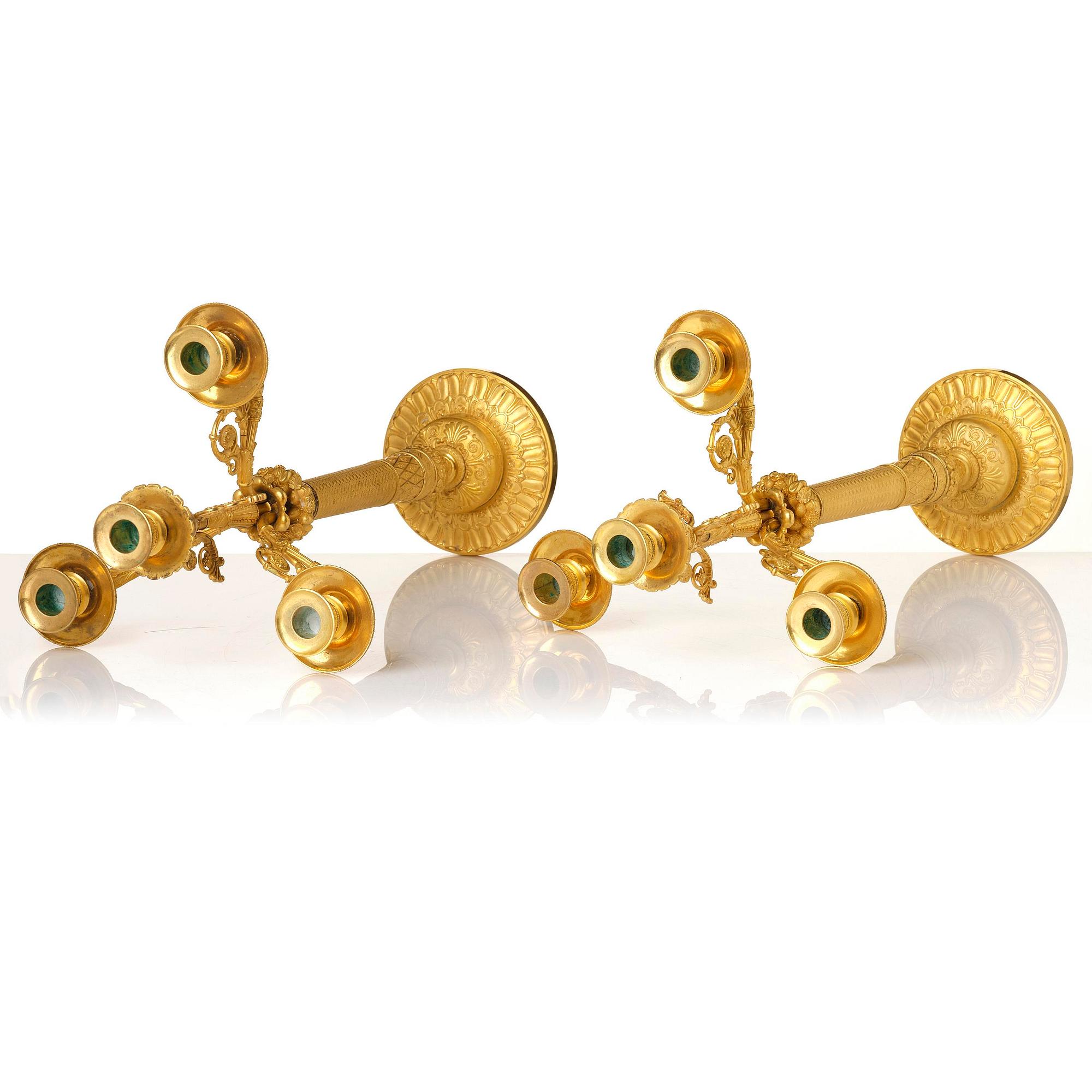 A pair of French Empire four-light gilt bronze candelabra, early 19th century.