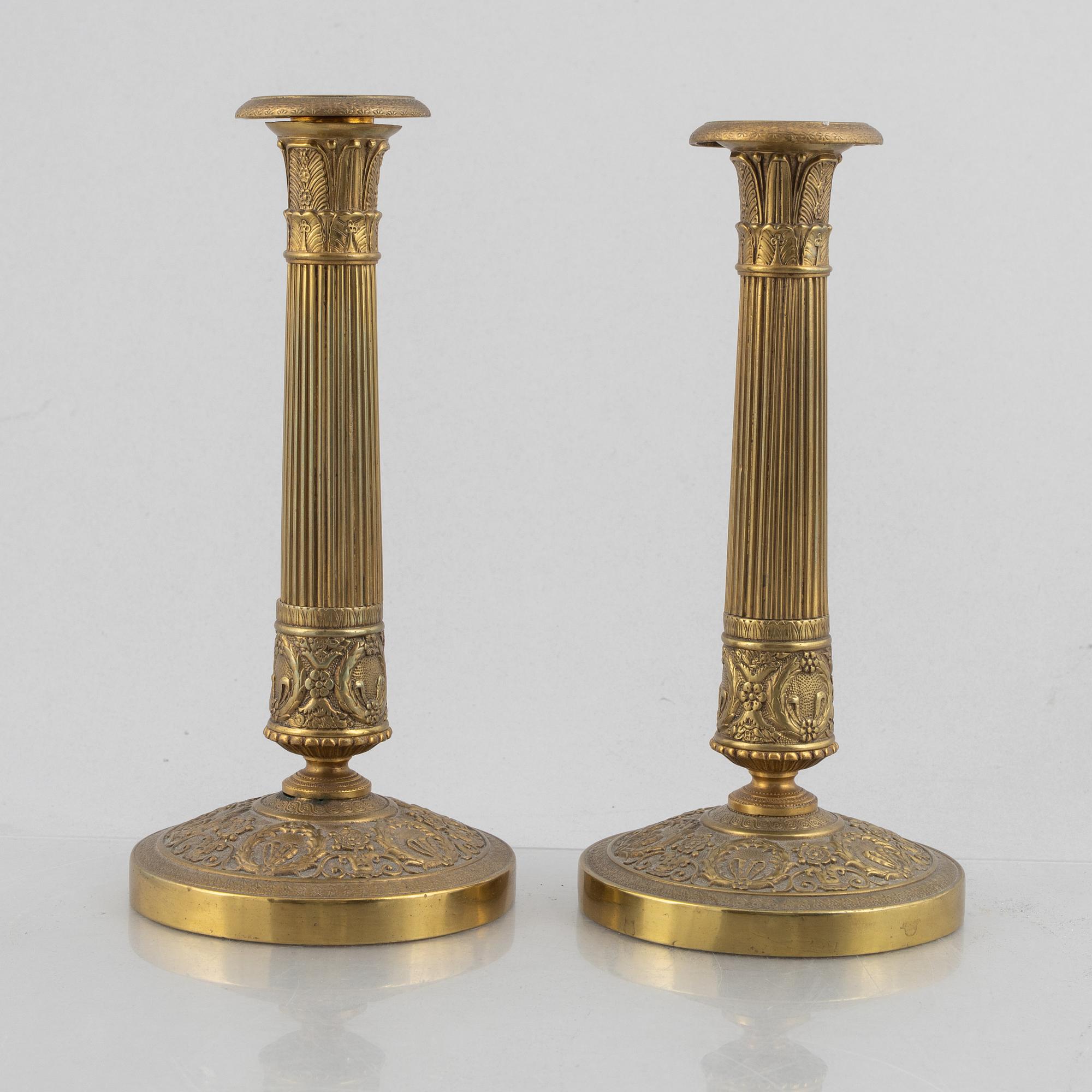 A pair of Empire gilt brass candle sticks, first half of the 20th century.