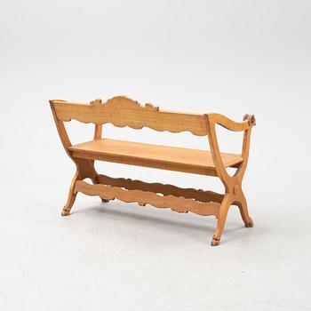A carved oak sofa, circa 1900.
