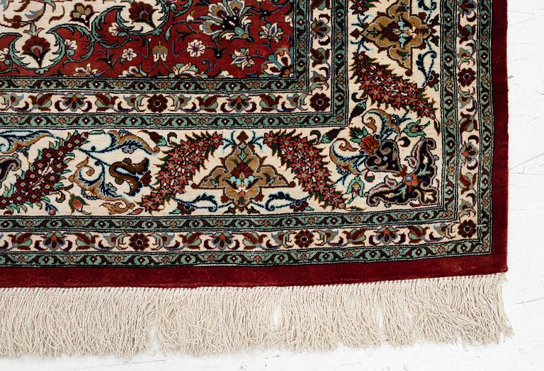 A Ghom silk rug, signed, c. 148 x 100 cm.